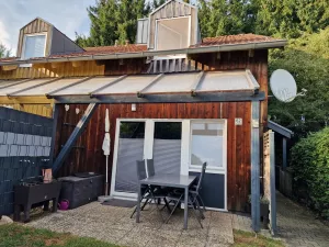 Terrasse mit Sitzgelegenheiten, Sichtschutz, großem Tisch, Kugelgrill, Sonnenschirm