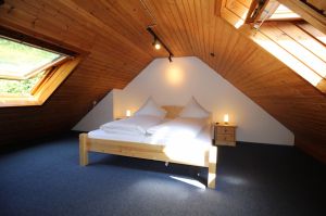 Das Schlafzimmer liegt auf der Empore und ein Doppelbett und 2 Dachfenster.