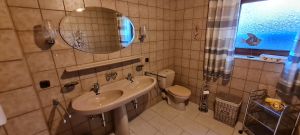 Badezimmer mit WC, Dusche, Badewanne und einem Doppelwaschbecken