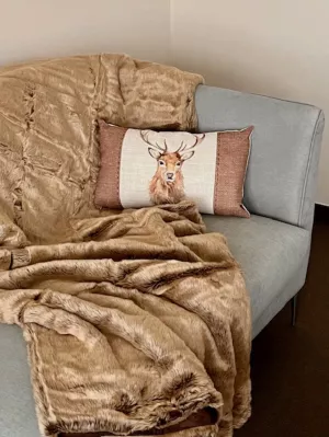 Sofa und Sessel mit gemütlichen Decken und Kissen für einen entspannten Aufenthalt